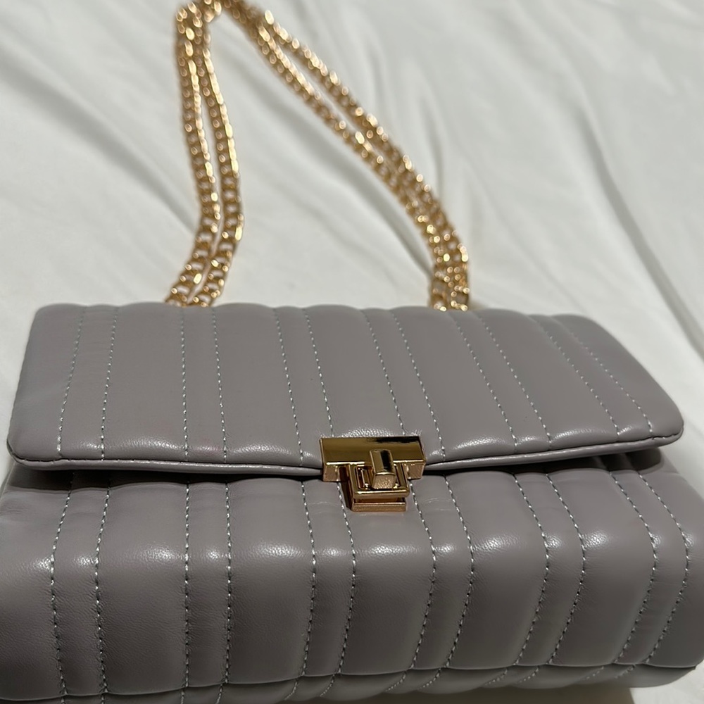 Grey crossbody or shoulder bag.